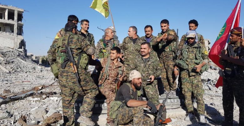 SDF and YBS fighters celebrate in Raqqa