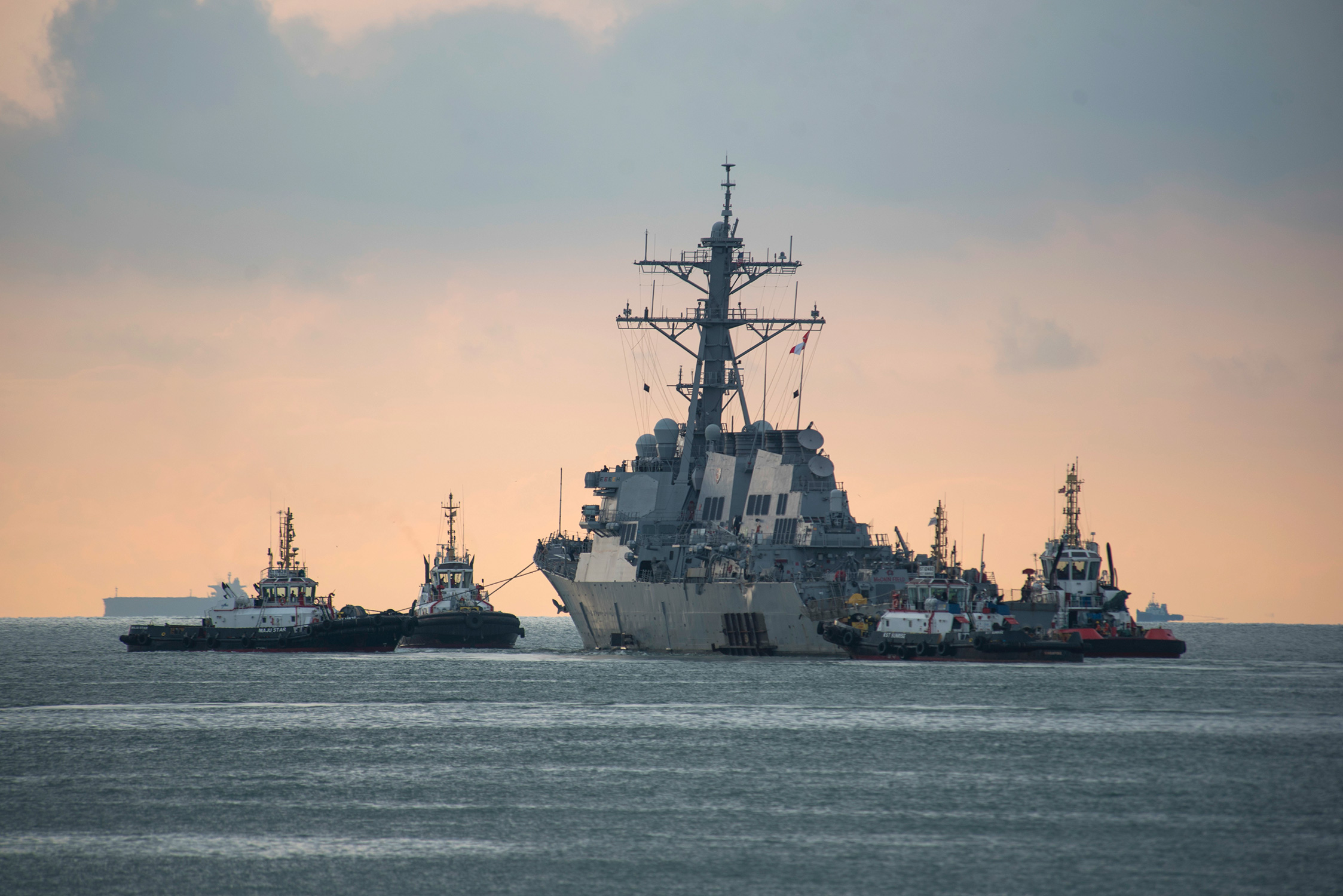USS John S. McCain towed for transport