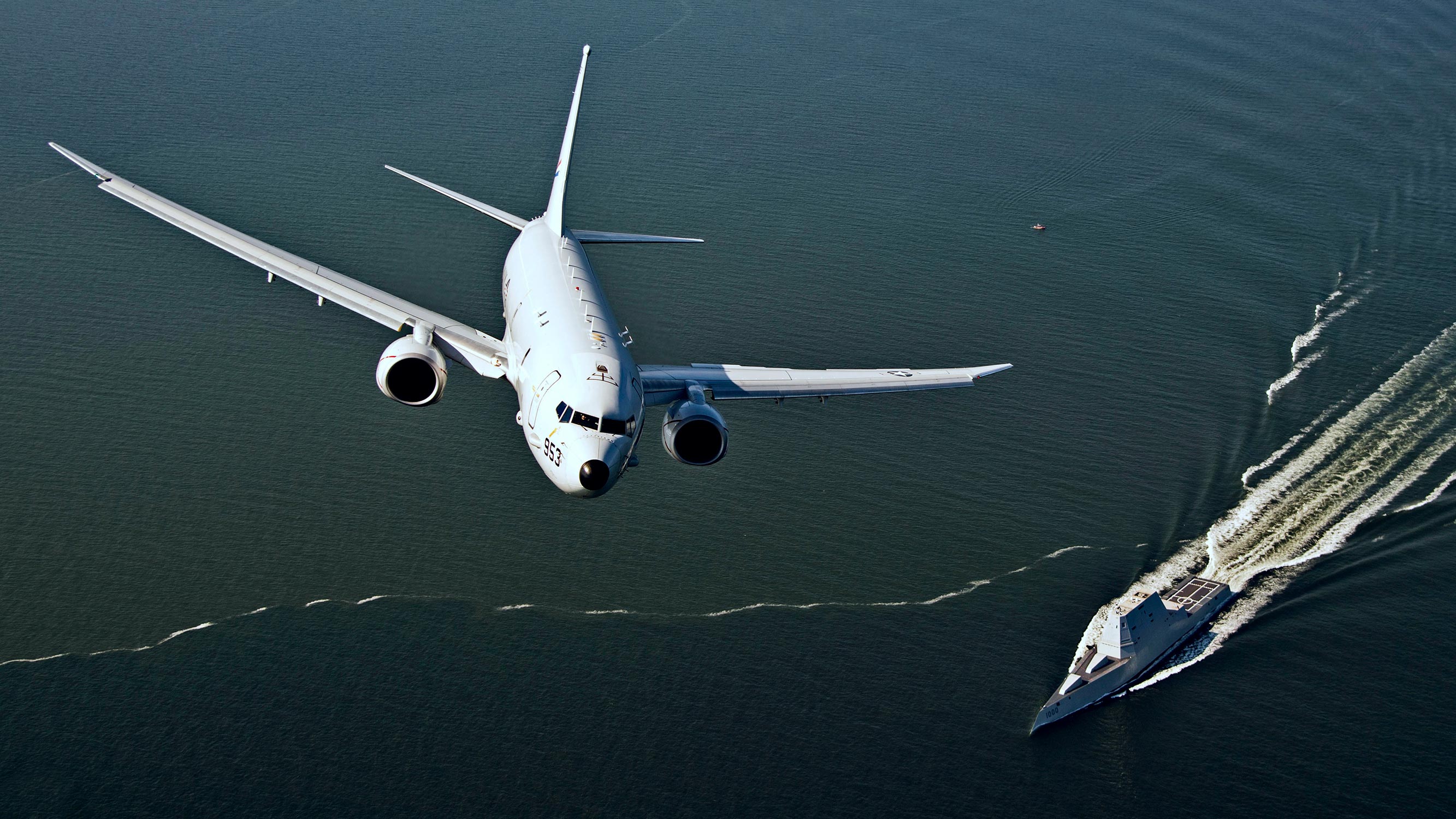 P-8A Poseidon flies over USS Zumwalt