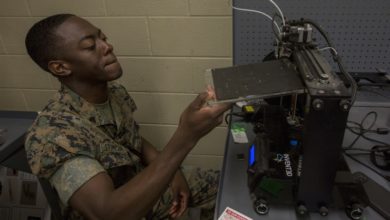 A U.S. Marine demonstrates how to use a 3d printer