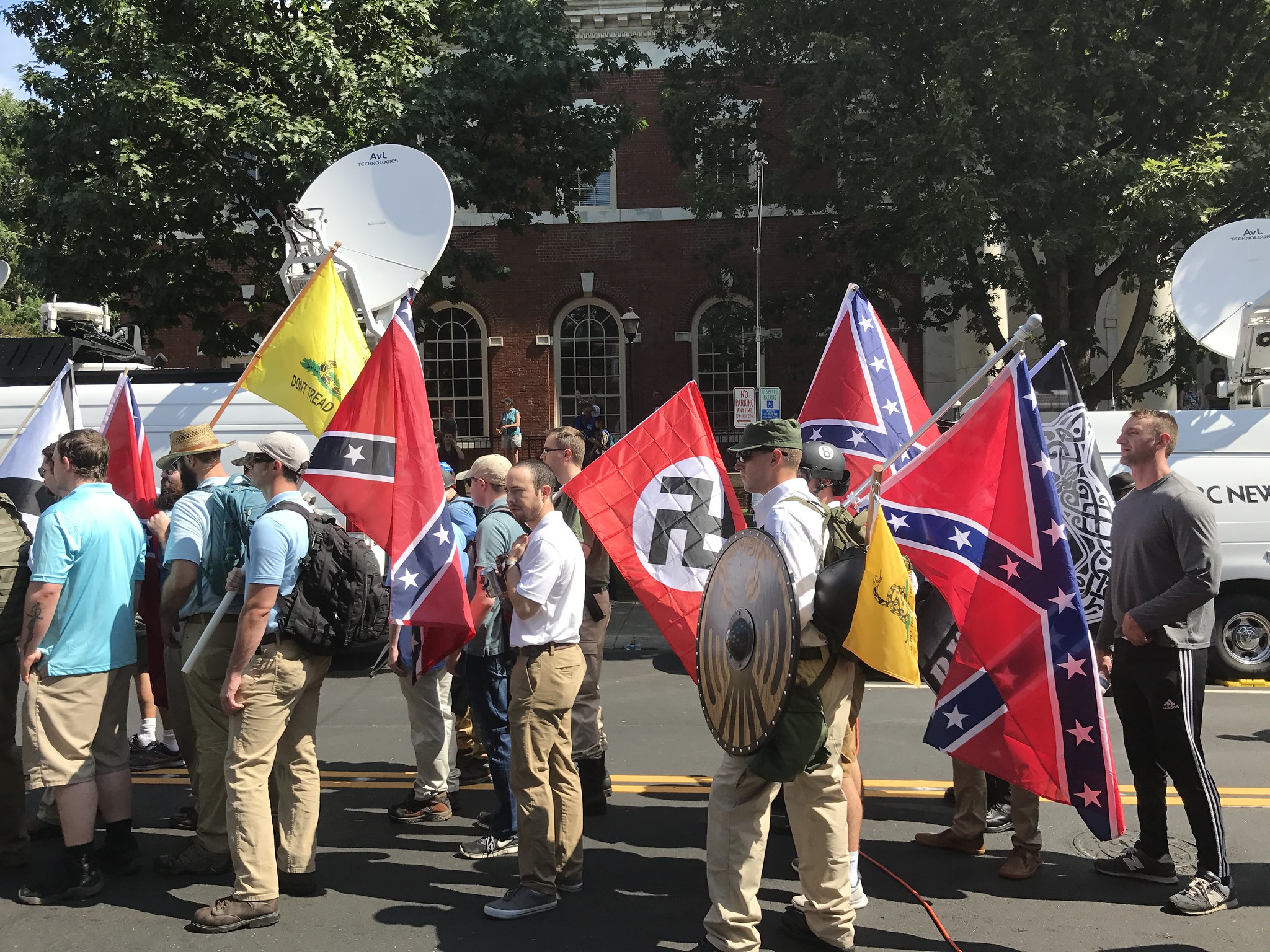 Alt-right members preparing to enter Emancipation Park holding Nazi, Confederate Battle, Gadsden "Don't Tread on Me," Southern Nationalist, and Thor's Hammer flags.