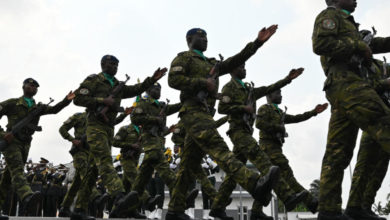 Ivory Coast army officers march during the funeral of Colonel Issiaka Ouattara,
