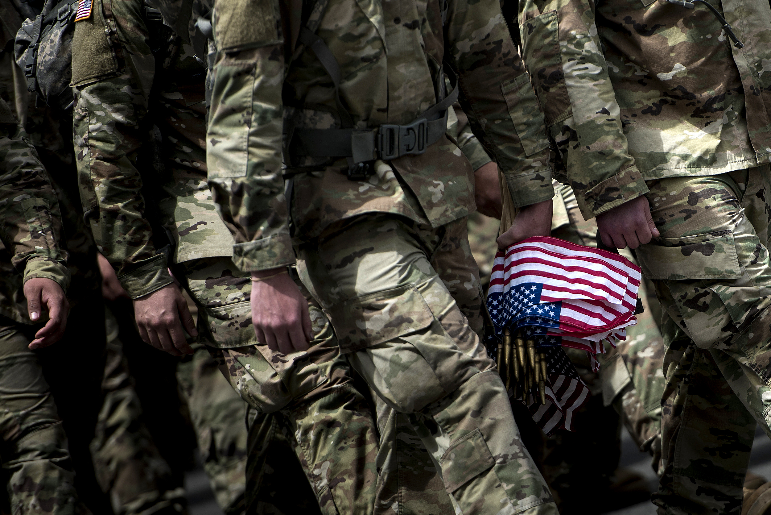 Soldiers in the Old Guard arrive to place flags at graves in Arlington National Cemetery during "Flags In" in preparation for Memorial Day May 25, 2017 in Arlington, Virginia.