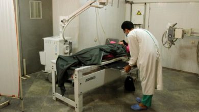 An injured woman is treated at a hospital after an air strike west of Kabul, Afghanistan on July 23, 2020.