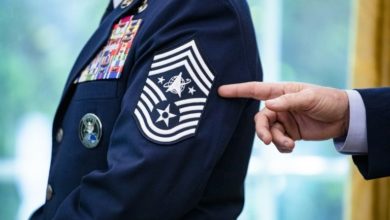 Chief Master Sgt. Roger Towberman displays his insignia during a presentation of the United States Space Force flag in the Oval Office of the White House, Friday, May 15, 2020.