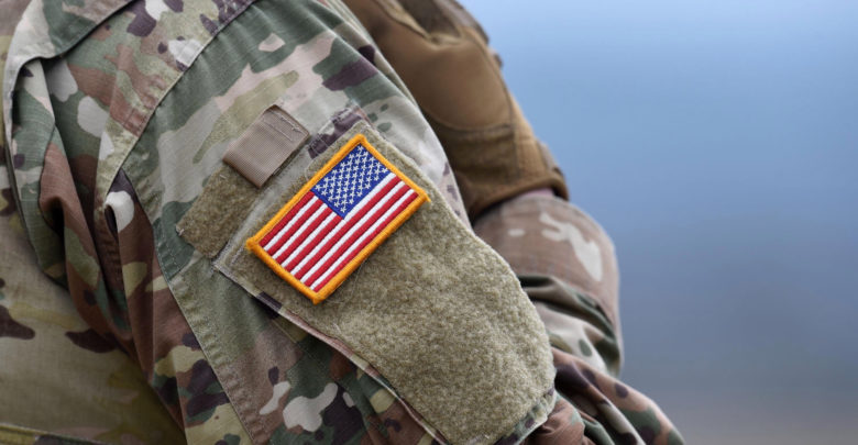 A US flag is pictured on a soldier's uniform during an artillery live fire event by the US Army Europe's 41st Field Artillery Brigade at the military training area in Grafenwoehr, southern Germany, on March 4, 2020.