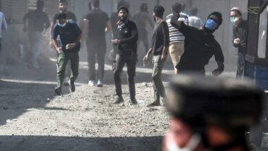 Protesters throw stones during clashes with government forces in Batamaloo area of Srinagar on September 17, 2020