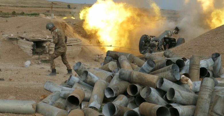 Photo of a Karabakh gunner firing an artillery piece towards Azeri positions.