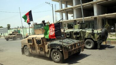 Afghan security personnel gather near a prison in Kabul.