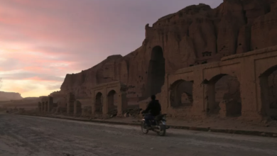 File: A man rides his motorbike during sunset in front of the empty seat of one of the two Buddha statues destroyed by the Taliban in 2001 in Bamiyan, on November 19, 2019