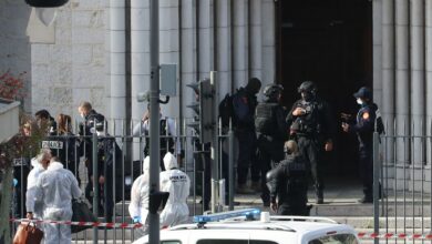 French members of the elite tactical police unit RAID enter to search the Basilica of Notre-Dame de Nice as forensics officers wait outside after a knife attack in Nice on October 29, 2020