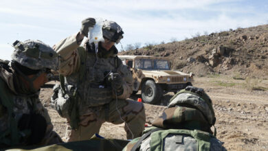 US soldiers assigned to 1st Squadron, 8th Cavalry Regiment, 2nd Brigade Combat Team, 1st Cavalry Division, care for simulated casualties during Decisive Action Rotation 17-04 at the National Training Center in Fort Irwin, California, 2017