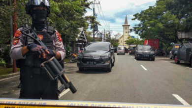An Indonesian anti-terror policeman stands guard following an explosion outside a church in Makassar, March 28, 2021