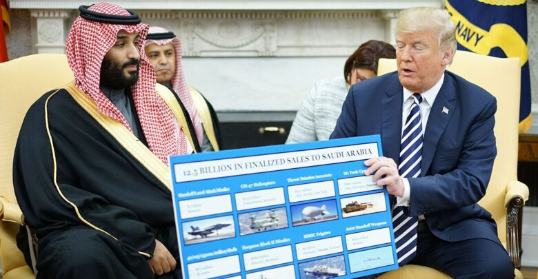 US President Donald Trump holds a defense sales chart with Saudi Arabia's Crown Prince Mohammed bin Salman in the Oval Office of the White House on March 20, 2018 in Washington, DC