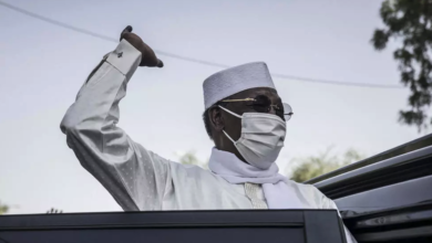 Chadian President Idriss Deby Itno greets supporters as he leaves after casting his ballot at a polling station in N'djamena on April 11, 2021.