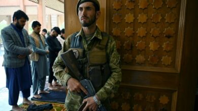 An Afghan soldier stands guard as Muslim devotees offer prayers to start the Eid-al-Fitr festival marking the end of the Islamic holy fasting month of Ramadan during a three-day ceasefire agreed by the warring Taliban and Afghan forces, at the Abdul Rahman Mosque in Kabul on May 13, 2021.