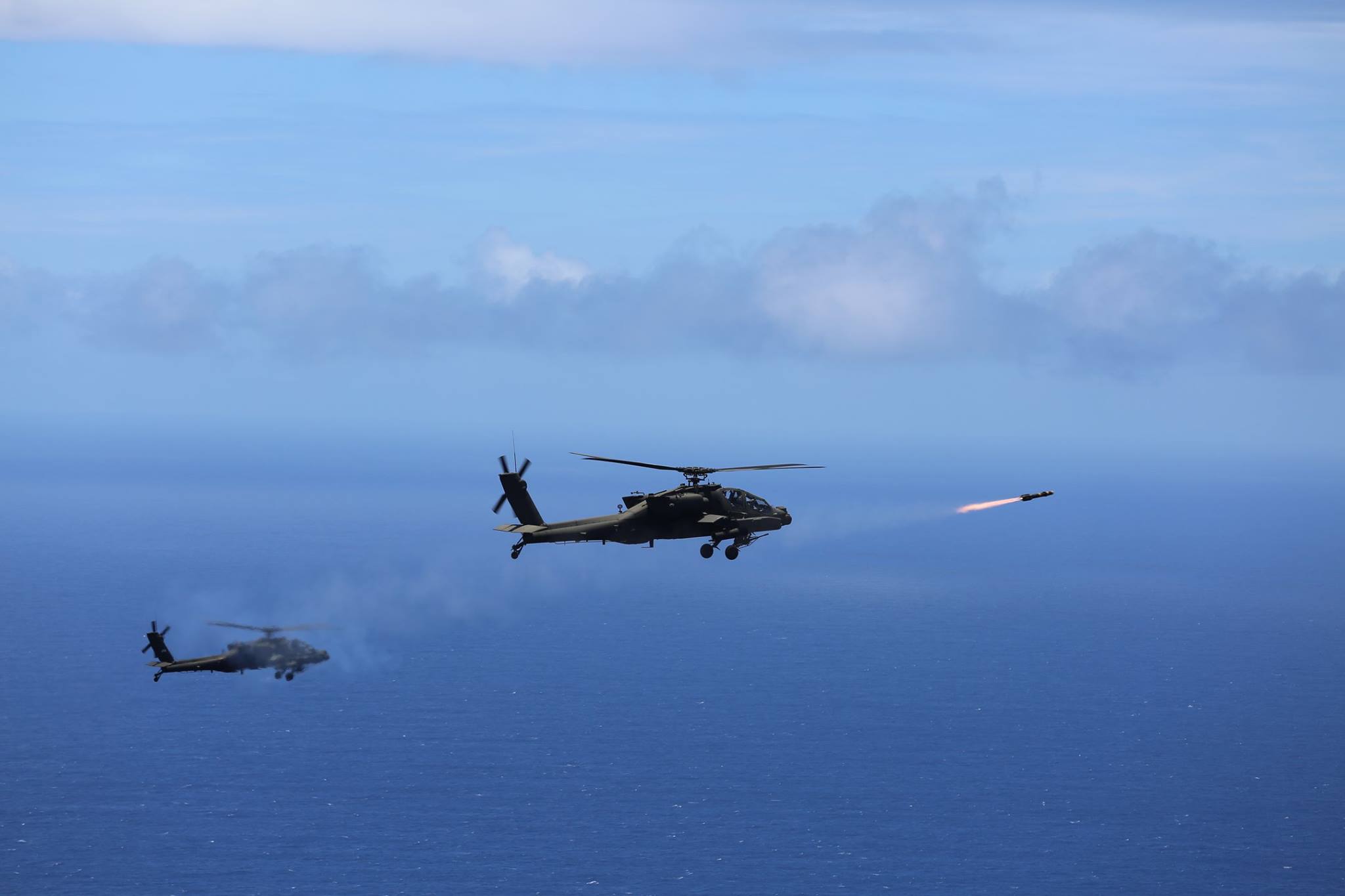 Two US Army AH-64D Apache attack helicopters launch eight "fire and forget" AGM-114L Hellfire Air to Surface Missiles during a training exercise off the coast of Oahu as part of the Rim of the Pacific in 2016.