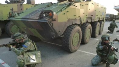 Taiwanese soldiers seen kneeling down beside armored vehicles dubbed the Clouded Leopards. Photo: Army Command Headquarters
