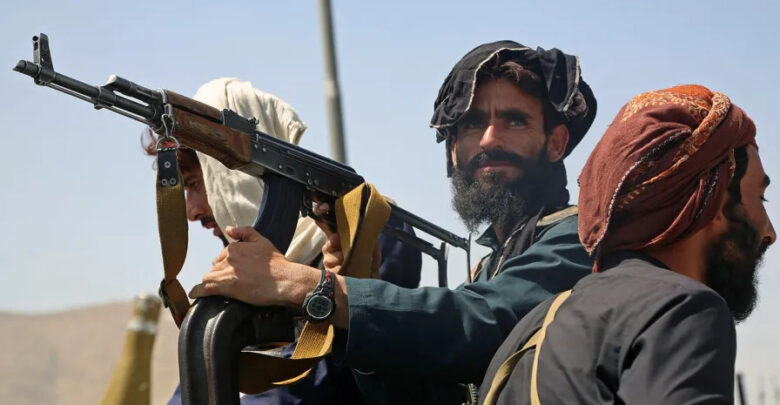 Taliban fighters stand guard in a vehicle along the roadside in Kabul on August 16, 2021