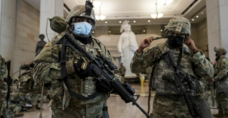 Virginia National Guard Soldiers prepare their gear for after resting in the Visitor Center in the US Capitol in Washington, DC, January 2021