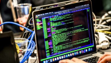 Closeup of hands working on a laptop