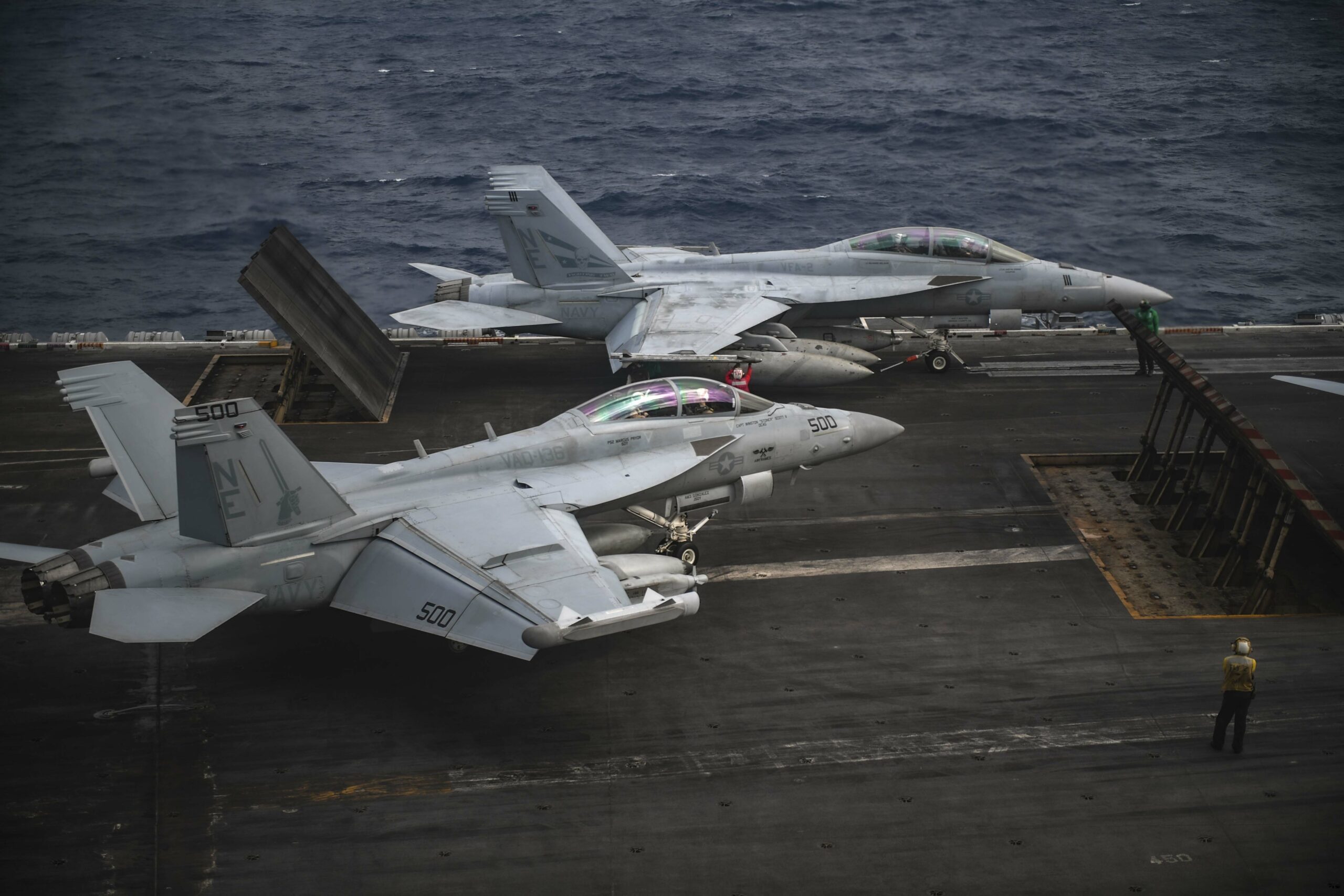 An F/A-18F Super Hornet and an EA-18G Growler prepare to launch
