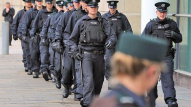 Police gather for the trial of loyalist gang members in Belfast