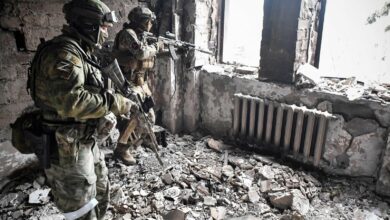 Two Russian soldiers patrol in the Mariupol drama theatre