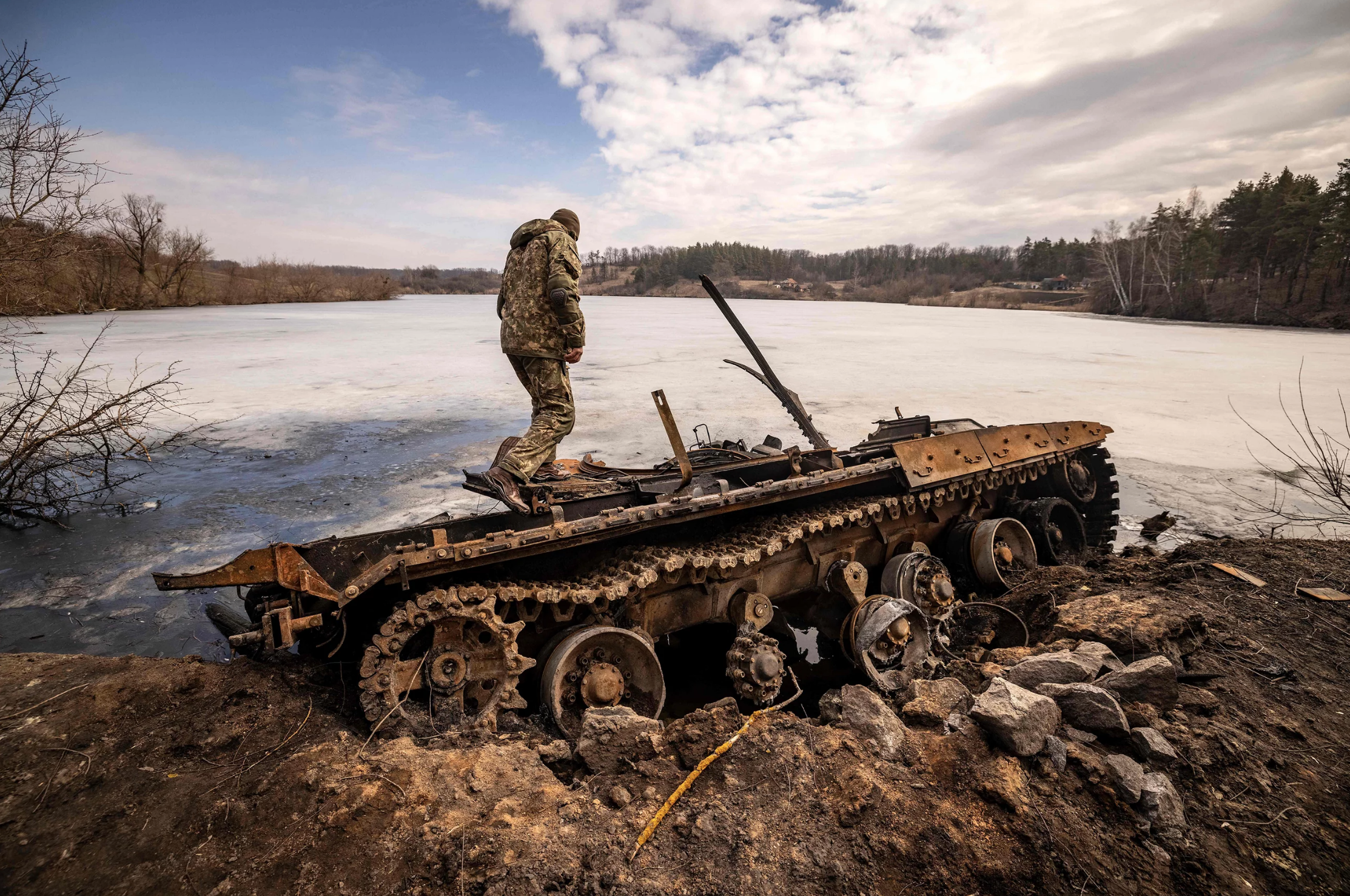 Ukrainian servicemember on destroyed Russian tank