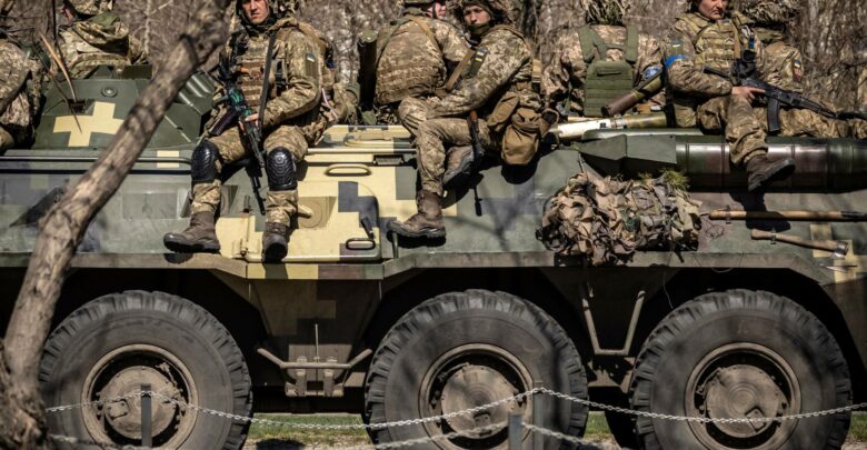 Ukrainian soldiers on top of an armored vehicle