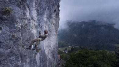 The Parachute Regiment paratrooper abseils down a cliff.