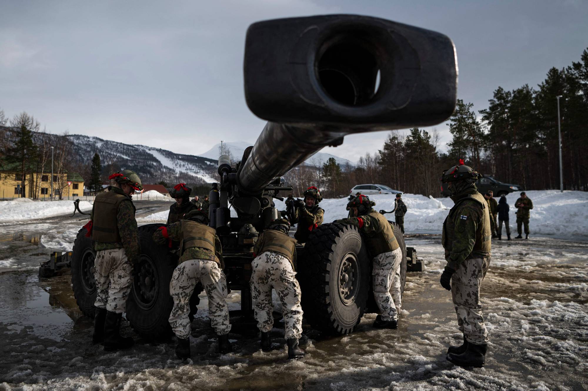 Soldiers from the Finnish Defense Forces operate the Tampella 155 K 83-97, a towed 155 mm field gun, during an international exercise in Setermoen, Norway, on March 22