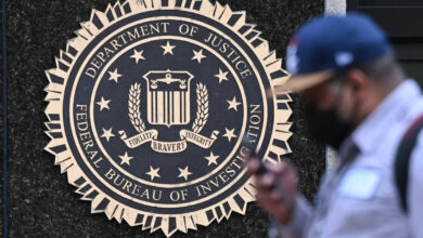 A pedestrian walks past the J. Edgar Hoover FBI building in Washington