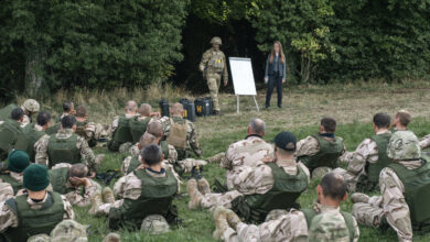 A New Zealand Army soldier presents to Ukrainian recruits in the UK