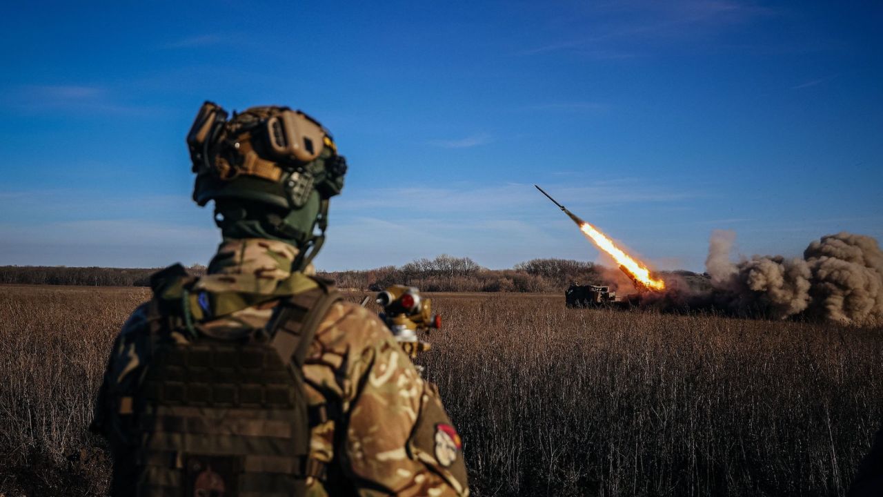 A Ukrainian soldier watches a self-propelled 220 mm multiple rocket launcher "Bureviy" firing towards Russian positions in eastern Ukraine