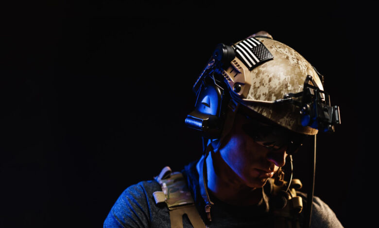 Portrait of special forces soldier in helmet and glasses in the dark