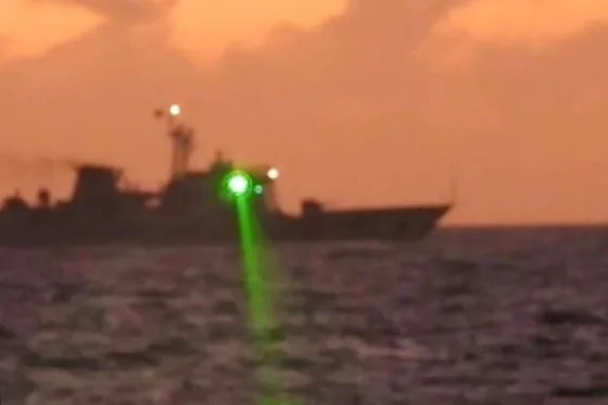 A Chinese coast guard vessel shines a "military grade laser light" at a Philippine coast guard boat in the disputed South China Sea