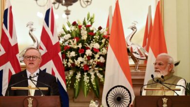 Indian Prime Minister Narendra Modi looks on as Australia's Prime Minister Anthony Albanese speaks during a joint media briefing