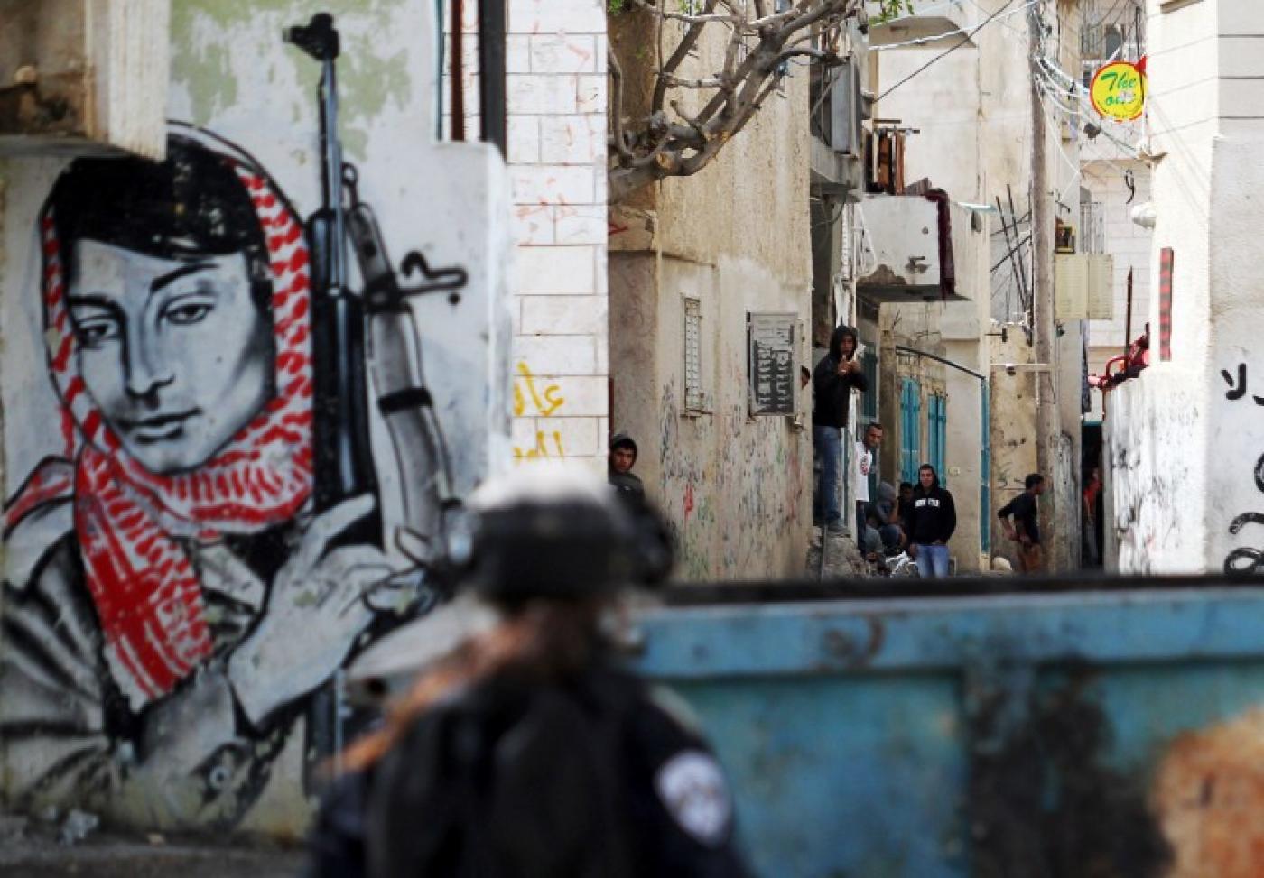Palestinian demonstrators in Bethlehem with PFLP member and Palestinian resistance symbol Leila Khaled in the background
