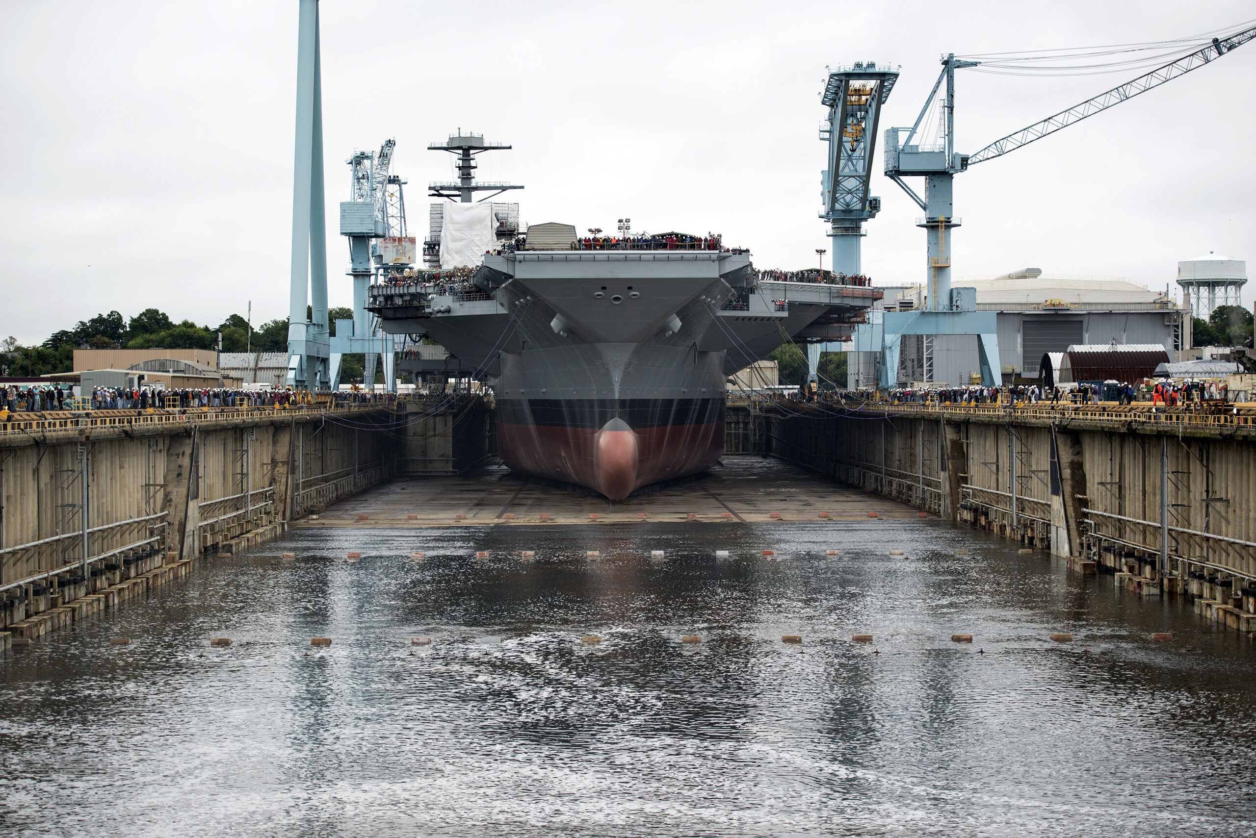 Newport News Shipbuilding floods Dry Dock 12 to float the first in class aircraft carrier, Pre-Commissioning Unit Gerald R. Ford (CVN 78). (U.S. Navy photo by Mass Communication Specialist 1st Class Joshua J. Wahl/Released)