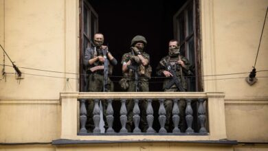 Members of Wagner group stand on the balcony of the circus building in the Russian city of Rostov-on-Don