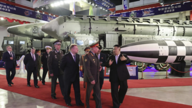 Leader Kim Jong Un (R) visits an exhibition of North Korean weaponry with visiting Russian Defense Minister Sergei Shoigu