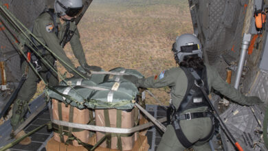 (l-r) No.35 Squadron loadmasters Warrant Officer Shaunn Segon and Corporal Mackenzie Golightly prepare to perform an airdrop over Mt. Bundy Range in the Northern Territory. *** Local Caption *** On 22 July 23, No. 35 Squadron (35SQN) completed interoperability training with Marine Rotational Force Darwin, conducting two airdrop flights over Mount Bundy Training Area in the Northern Territory. The C-27J Spartan dropped four Light Equipment and three Container Delivery System loads each flight. The United States Marine Corps personnel conducted the Drop Zone survey, constructed the airdrop loads, and performed drop zone safety officer duties on the ground, enabling the airdrop to occur. This training achieved further synergy between Australia and partner nations, strengthening our important partnership with the United States. 35SQN is located at RAAF Base Amberley, Queensland, with a C-27J is currently based in Darwin for Exercise Talisman Sabre until early August.