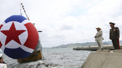 North Korean leader Kim Jong Un next to the country's new submarine