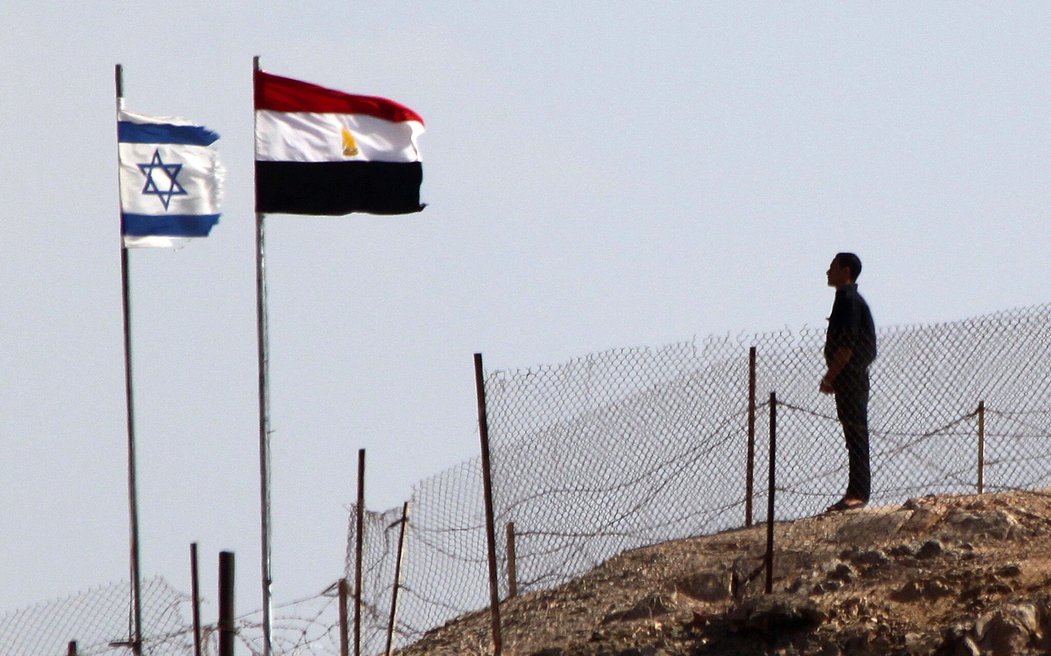 An Egyptian soldier stands guard at the Taba crossing between Egypt and Israel