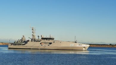 ADV Cape Pillar, Australia's newest Evolved Cape-Class Patrol Boat, is seen docked in a pier. Its hull is colored grey, with the numbers "319" painted in white on the side of the bow.