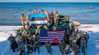 Estonian and US Army soldiers pose with the US Army’s Maneuver Short Range Air Defense Stryker