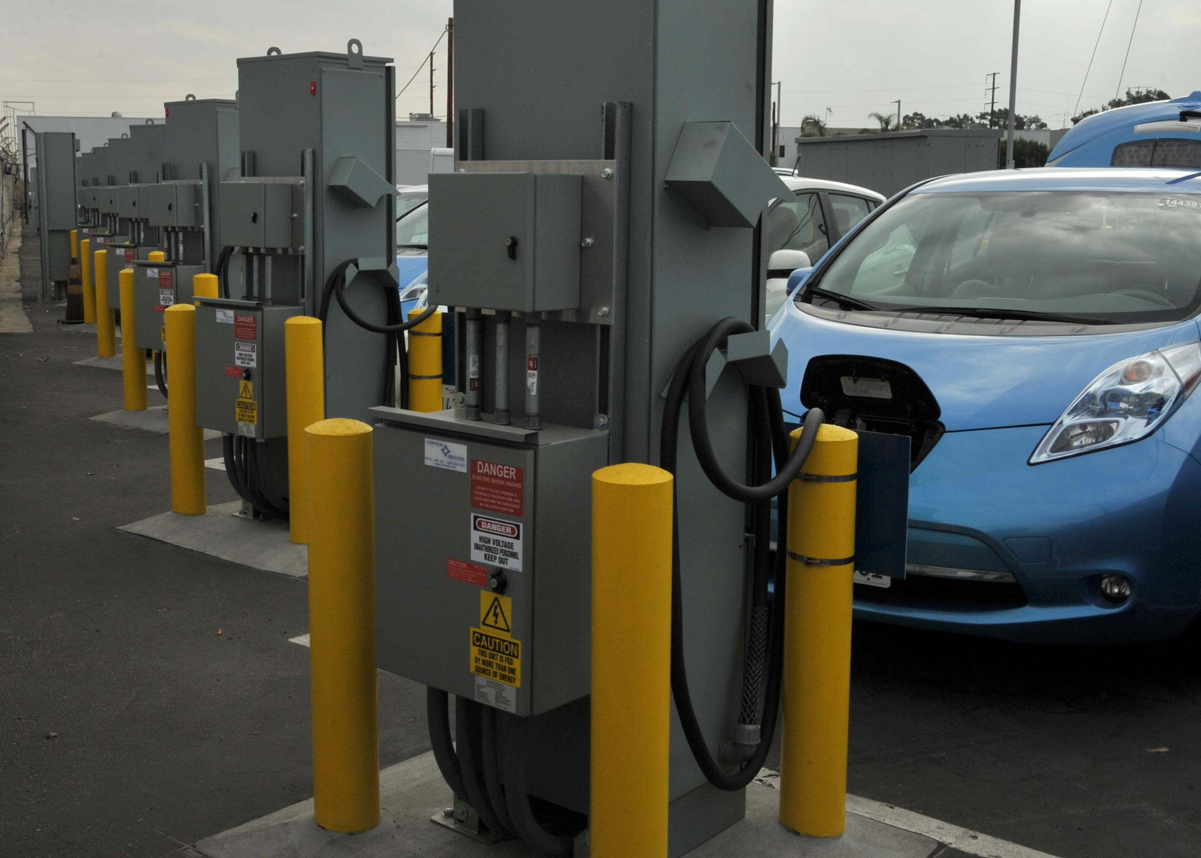 A fleet of plug-in electric vehicles sits ready to roll at Los Angeles Air Force Base in El Segundo, Calif., on Oct. 31, 2014. The new fleet is the first installation in the Department of Defense to replace its entire non-tactical fleet with electric and hybrid vehicles. The electric vehicles will charge directly from the local utility grid enabling Los Angeles AFB personnel to utilize the electric vehicles as transportation within the base. When called-upon, and when connected to the electric vehicle, the bi-directional charging station will switch power flow directions in order to support vehicle-to-grid energy request by discharging the electric vehicle’s onboard battery. (U.S. Air Force photo by Sarah Corrice/RELEASED.)