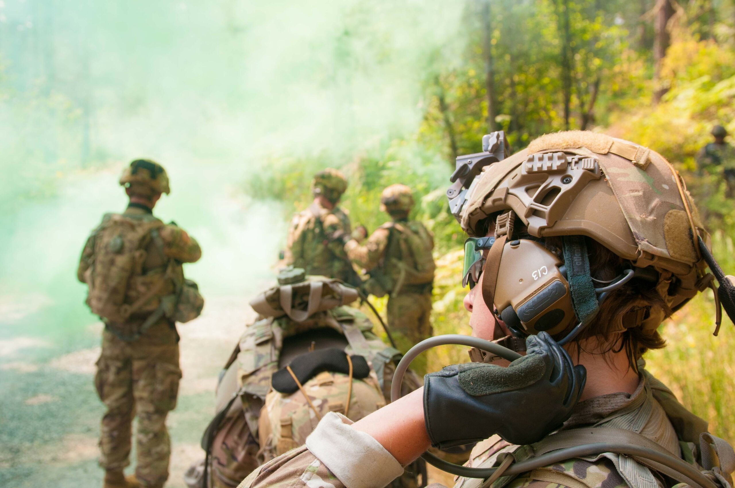 A soldier reaches for her drink tube during an operational test of the Integrated Head Protection System