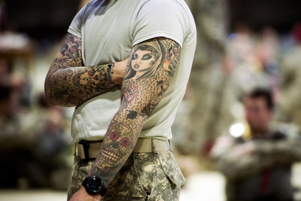 soldier with full-sleeve tattoos